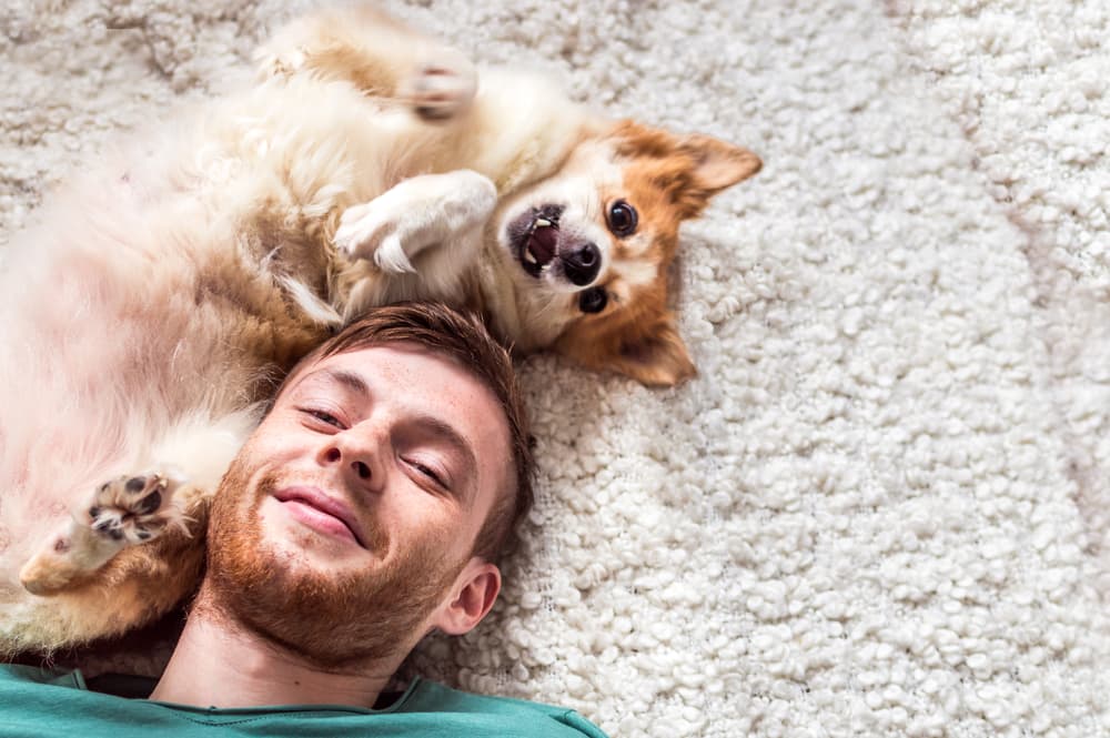 A man and his dog on the floor