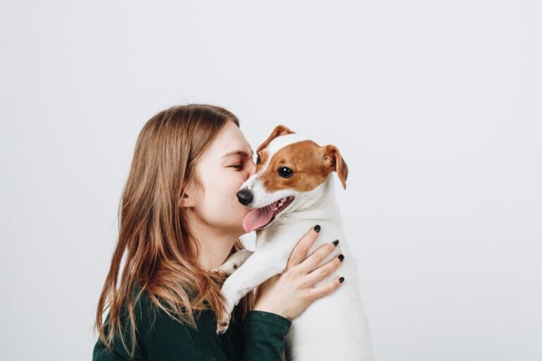 Woman hugging dog with bad breath
