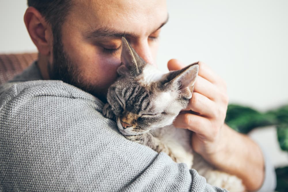 Man holding cat securely