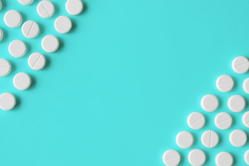 white pills on blue background
