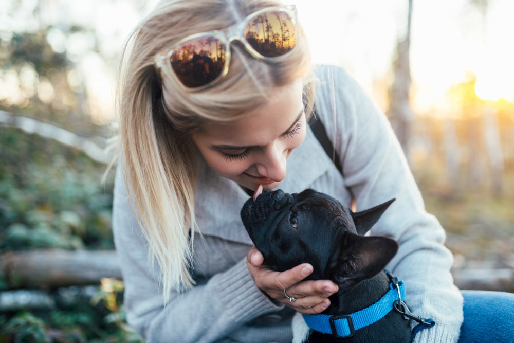 Woman hugging French bulldog