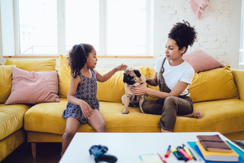 Mother and daughter with Pug