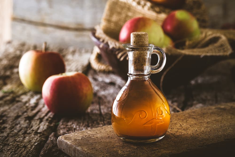 Apple cider vinegar on table