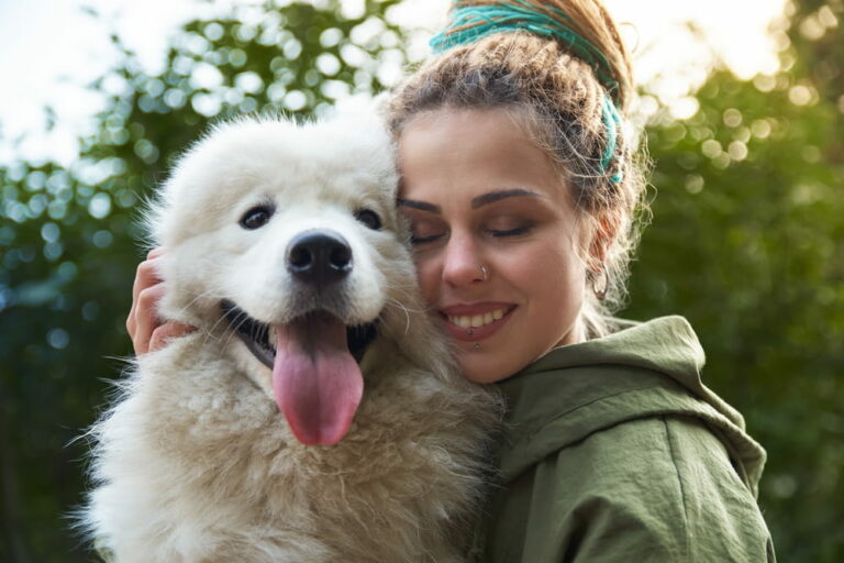 Woman cuddling big fluffy dog