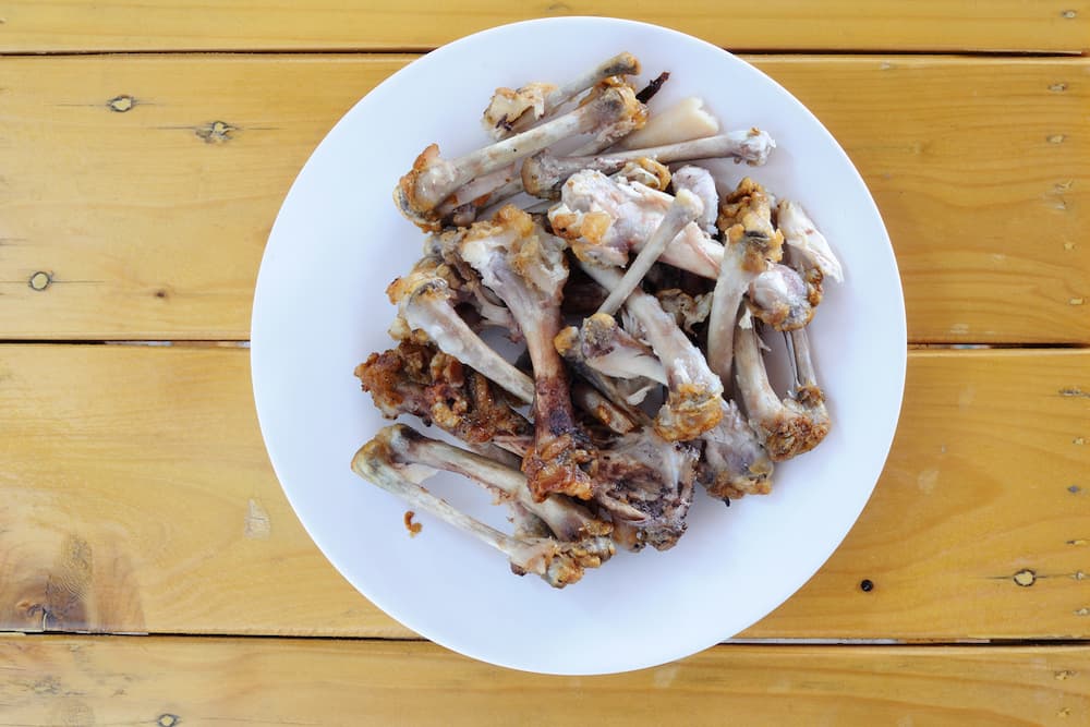 Chicken bones on a plate on the table