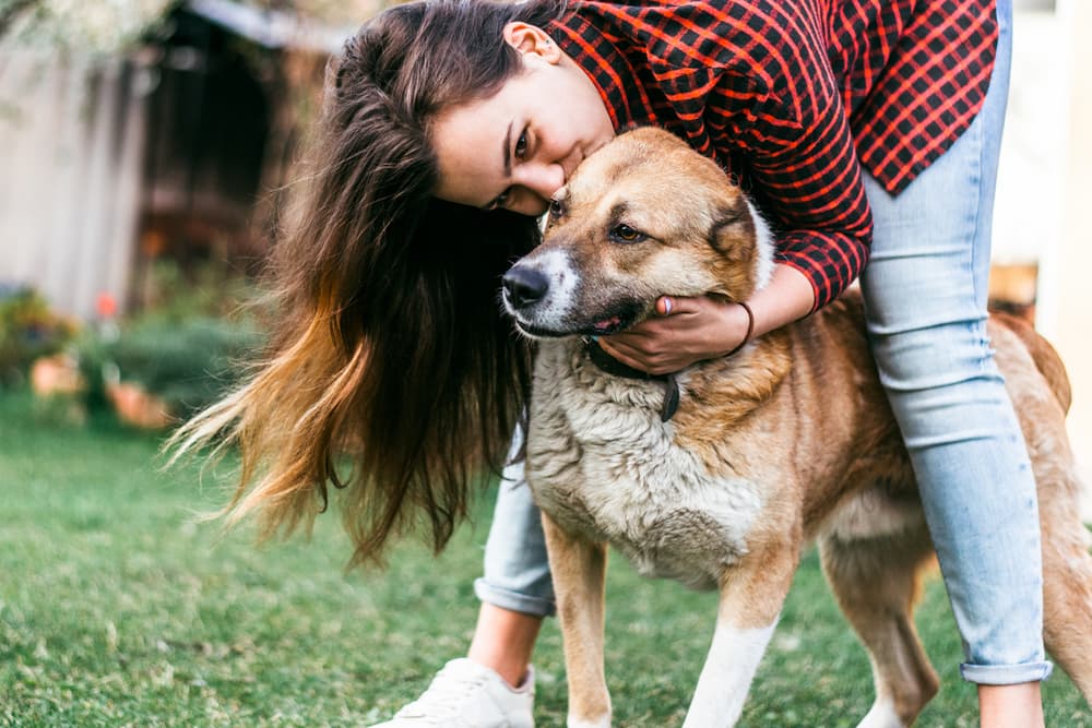 Owner holding dog for spot pet insurance review