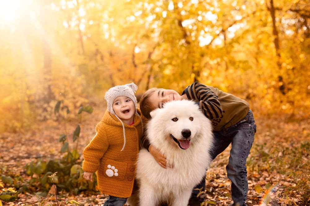 Big white dog with kiddos outside, good inspiration for big dog names