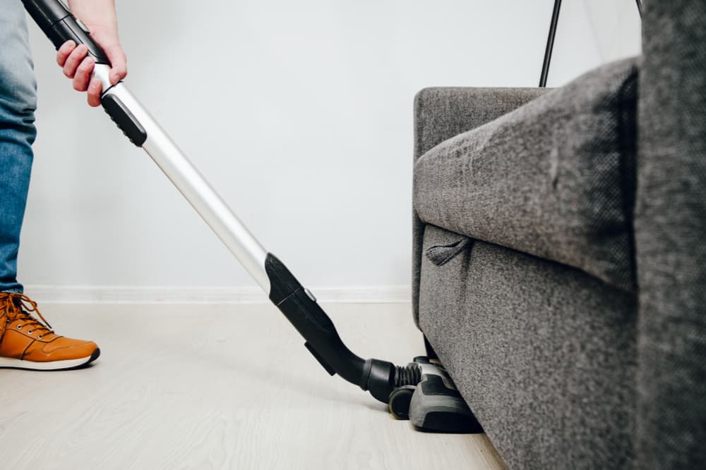 Vacumming underneath the couch