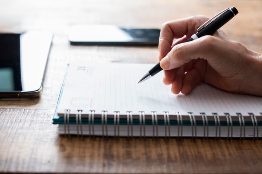 Woman taking notes in a notebook
