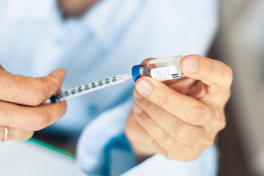 Pet owner holding bottle of insulin