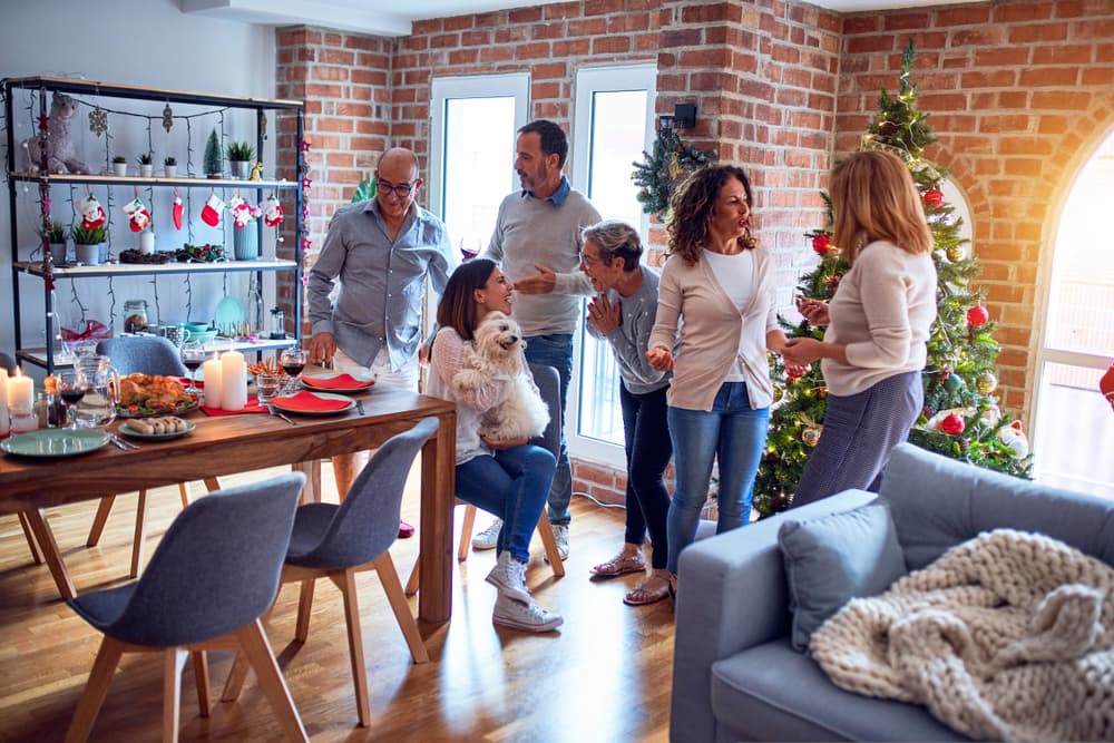 People gathered at a holiday party with dog