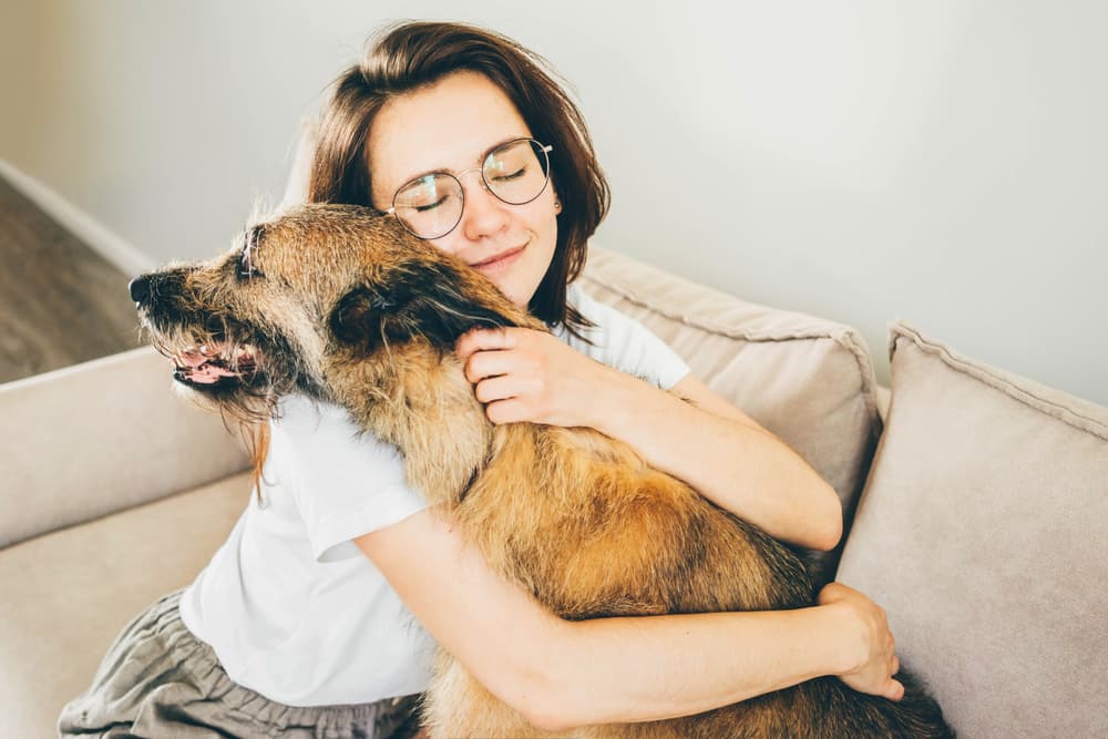 Woman hugging old dog