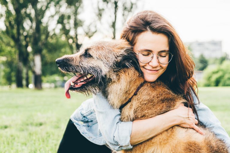 Woman hugging senior dog