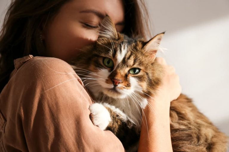 Woman hugging her cat